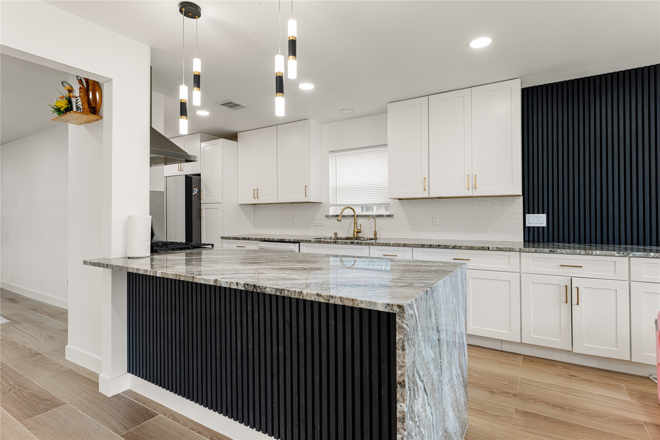 3410 Tanglewilde Street Houston, TX 77063 - Photo 7 of 17 a kitchen with granite countertop a sink a stove and cabinets