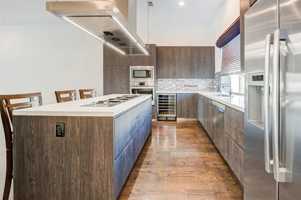 a kitchen with stainless steel appliances granite countertop a sink stove and refrigerator