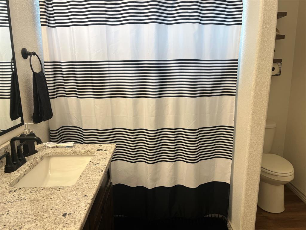 108 Wiley Stephenville, TX 76401 - Photo 11 of 25 a bathroom with a sink and a mirror