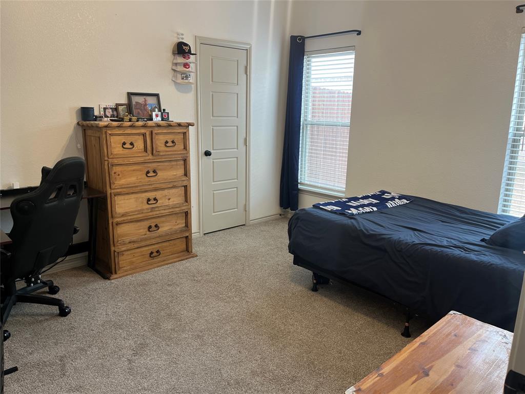 108 Wiley Stephenville, TX 76401 - Photo 12 of 25 a bedroom with a bed and a television