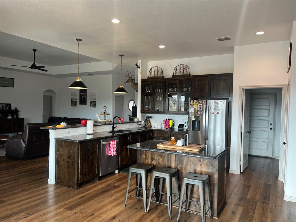 108 Wiley Stephenville, TX 76401 - Photo 20 of 25 a kitchen with stainless steel appliances granite countertop a stove and refrigerator