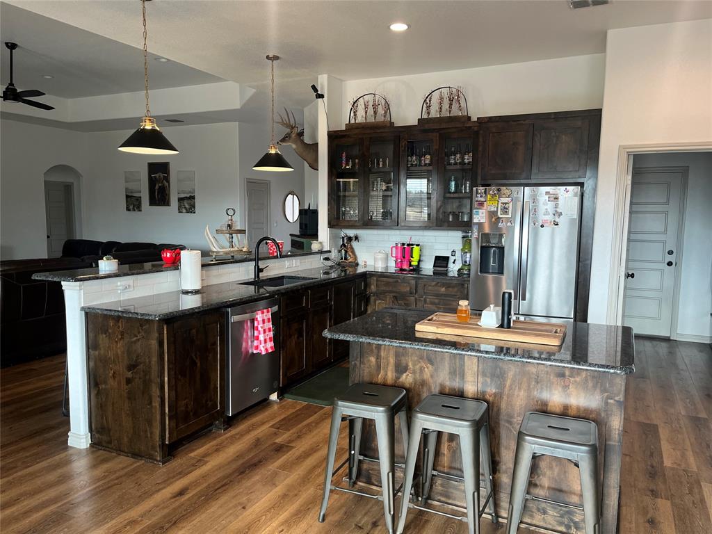 108 Wiley Stephenville, TX 76401 - Photo 4 of 25 a kitchen with stainless steel appliances granite countertop a stove refrigerator and cabinets