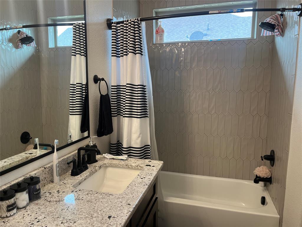 108 Wiley Stephenville, TX 76401 - Photo 10 of 25 a bathroom with a granite countertop sink and a mirror