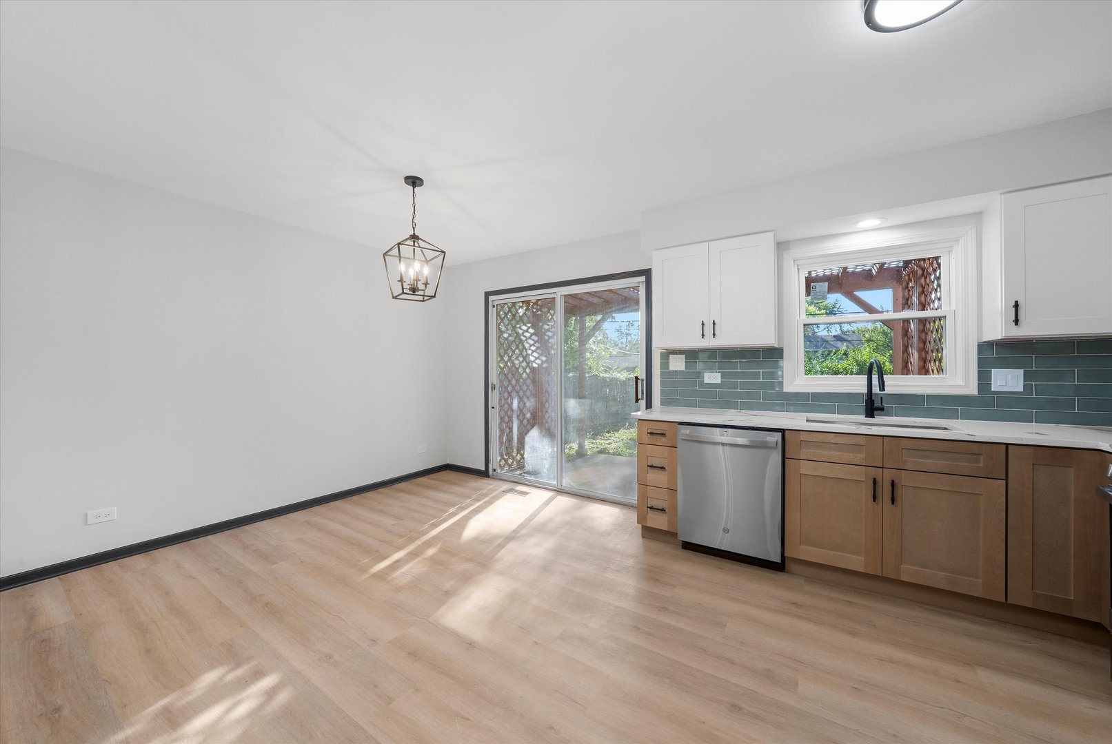 8040 Geneva Street Woodridge, IL 60517 - Photo 11 of 32 a large kitchen with granite countertop a sink cabinets stainless steel appliances and a counter space