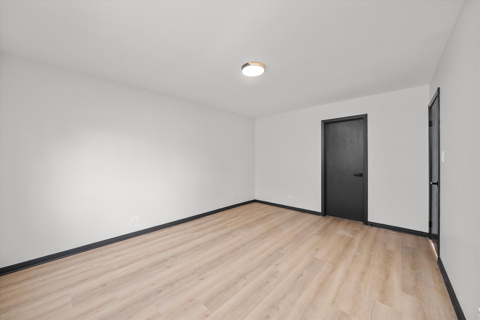8040 Geneva Street Woodridge, IL 60517 - Photo 18 of 32 a view of an empty room with wooden floor and closet