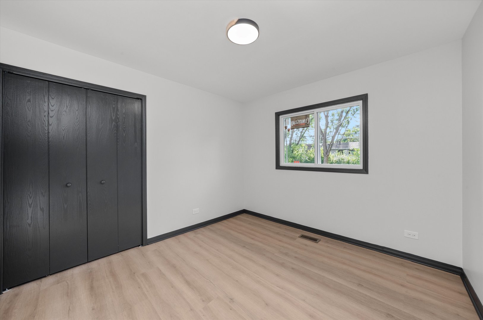 8040 Geneva Street Woodridge, IL 60517 - Photo 24 of 32 a view of an empty room with wooden floor and window
