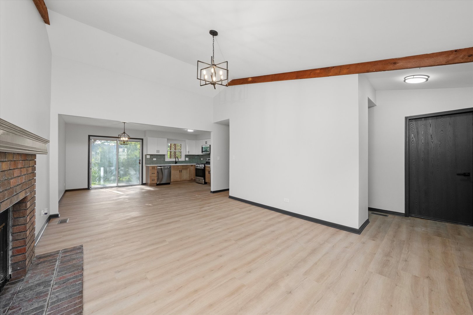 8040 Geneva Street Woodridge, IL 60517 - Photo 4 of 32 a view of empty room with wooden floor and fireplace