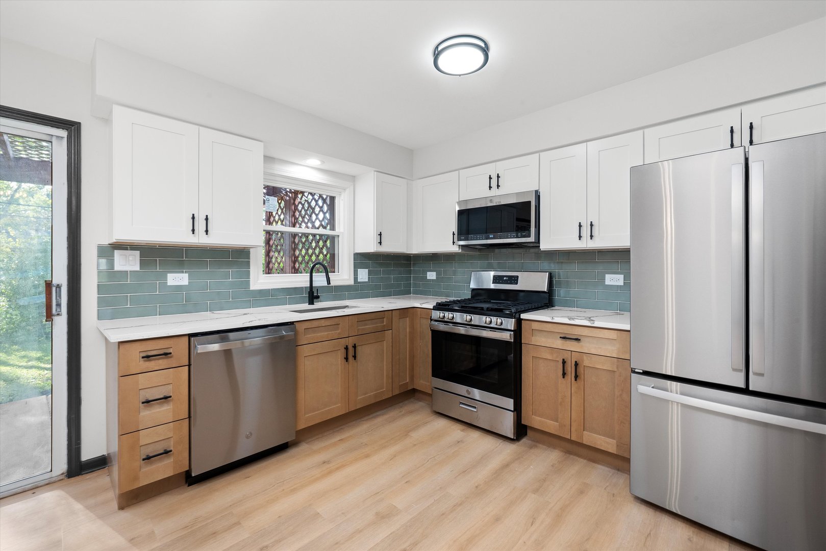 8040 Geneva Street Woodridge, IL 60517 - Photo 7 of 32 a kitchen with granite countertop a refrigerator stove top oven and sink