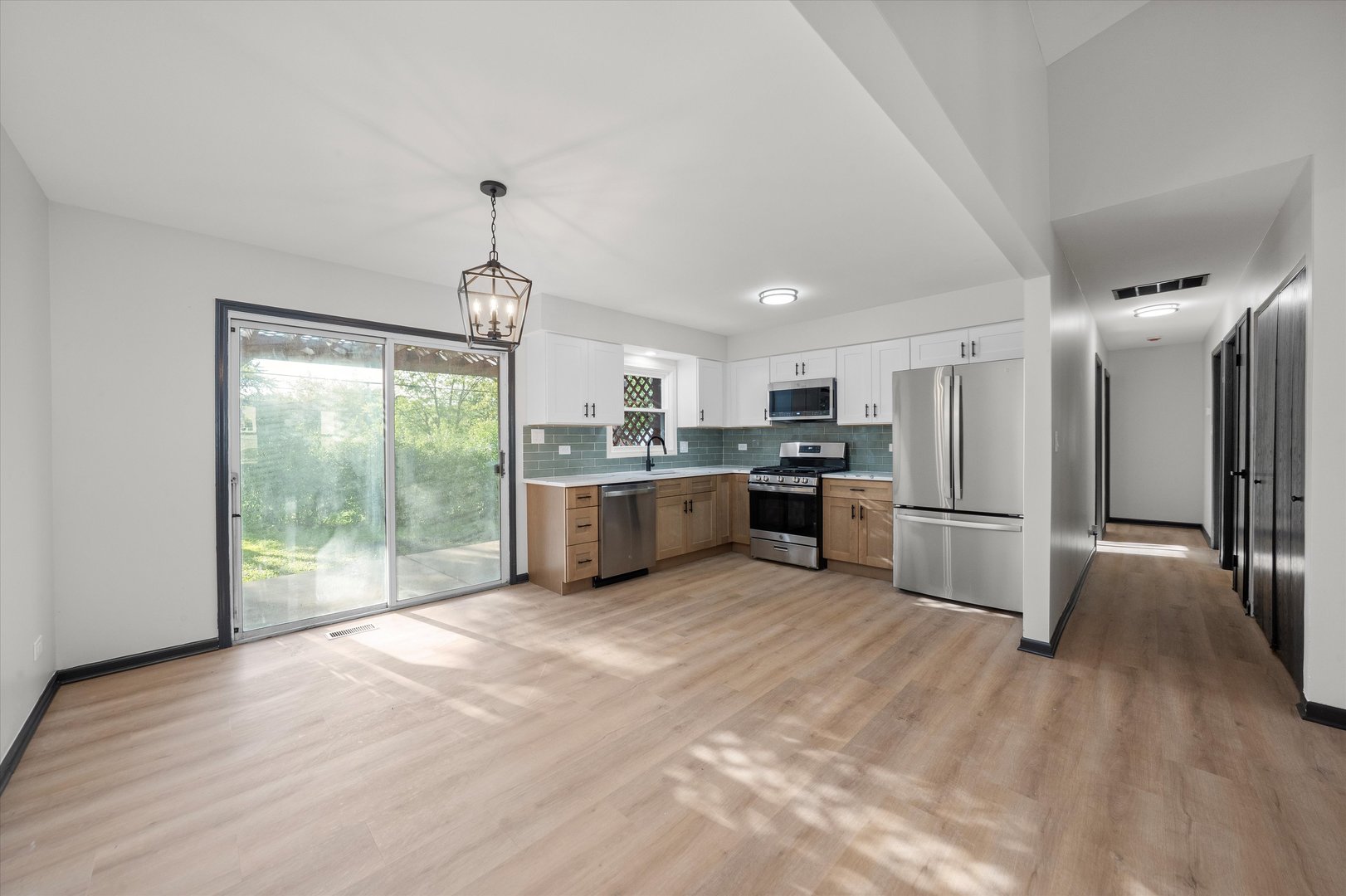 8040 Geneva Street Woodridge, IL 60517 - Photo 10 of 32 a kitchen with stainless steel appliances a refrigerator sink and wooden floor