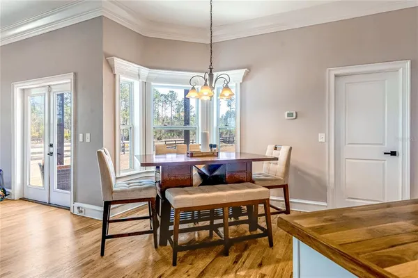 a kitchen with kitchen island granite countertop a stove top oven a sink a counter space and cabinets