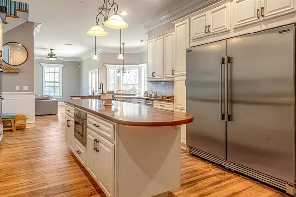 a dining room with furniture potted plants and wooden floor