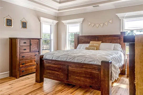 a bedroom with a bed and wooden floor