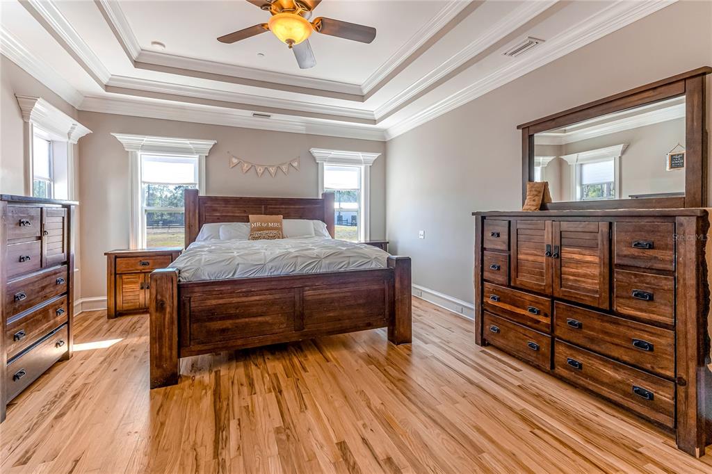 34175 Steeple Chase Way Callahan, FL 32011 - Photo 19 of 66 a bedroom with a bed and wooden floor