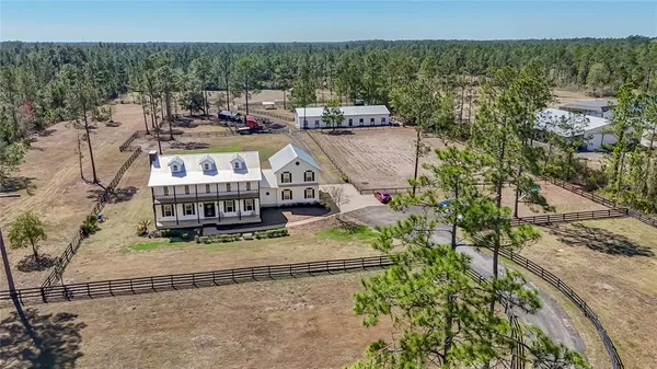 an aerial view of a house with a yard and balcony