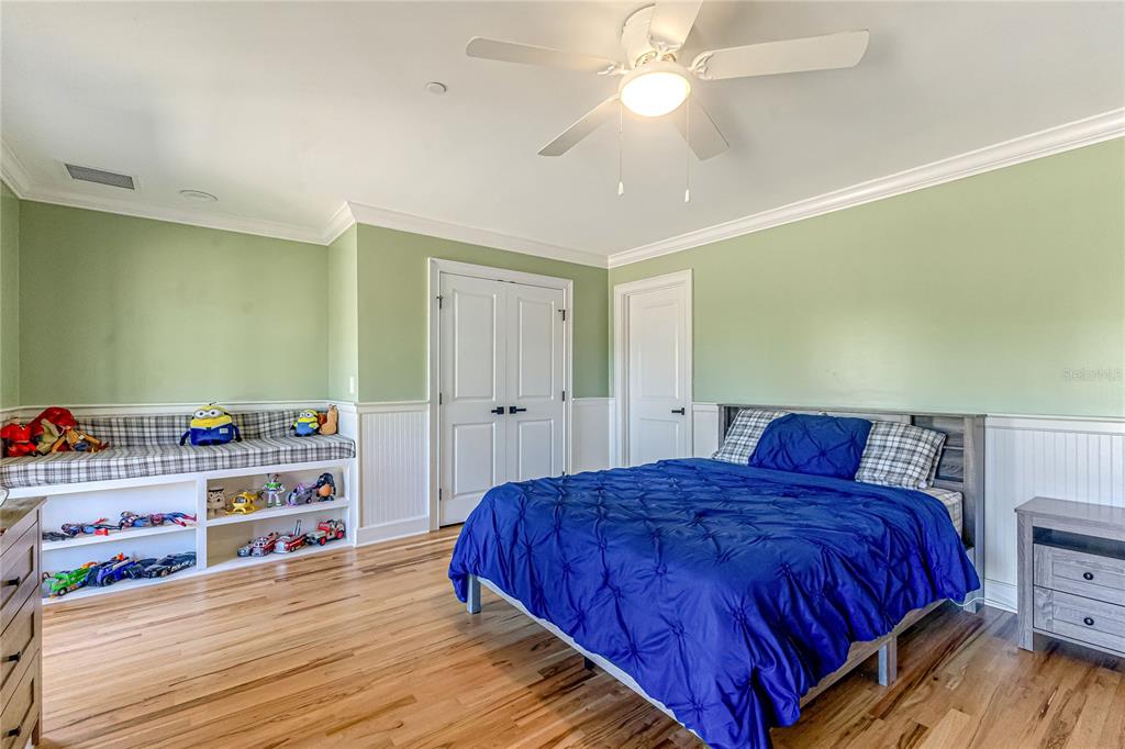 34175 Steeple Chase Way Callahan, FL 32011 - Photo 31 of 66 a bedroom with a bed and a chandelier