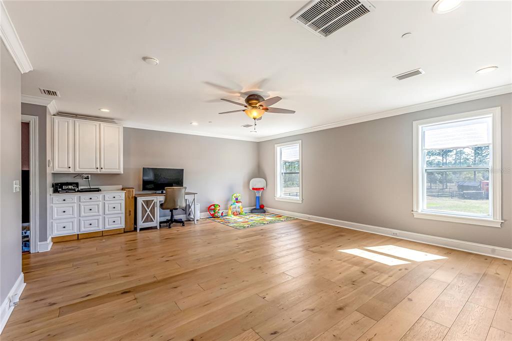 34175 Steeple Chase Way Callahan, FL 32011 - Photo 36 of 66 a view of a livingroom with furniture a ceiling fan and window