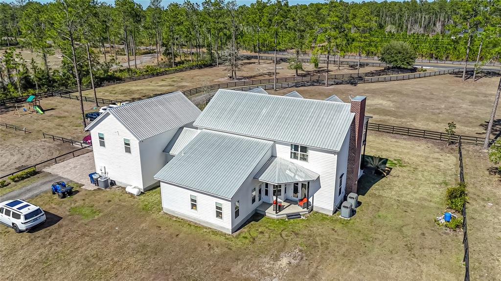 34175 Steeple Chase Way Callahan, FL 32011 - Photo 6 of 66 an aerial view of a house with swimming pool and large trees