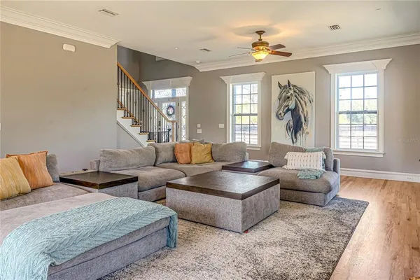 a living room with couches a fireplace and a flat screen tv