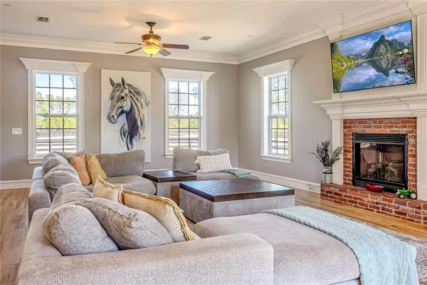 a living room with furniture a fireplace and a chandelier