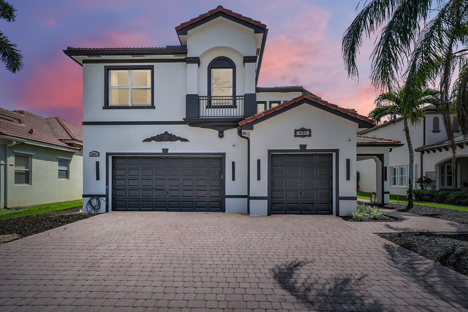 a front view of a house with a yard and garage