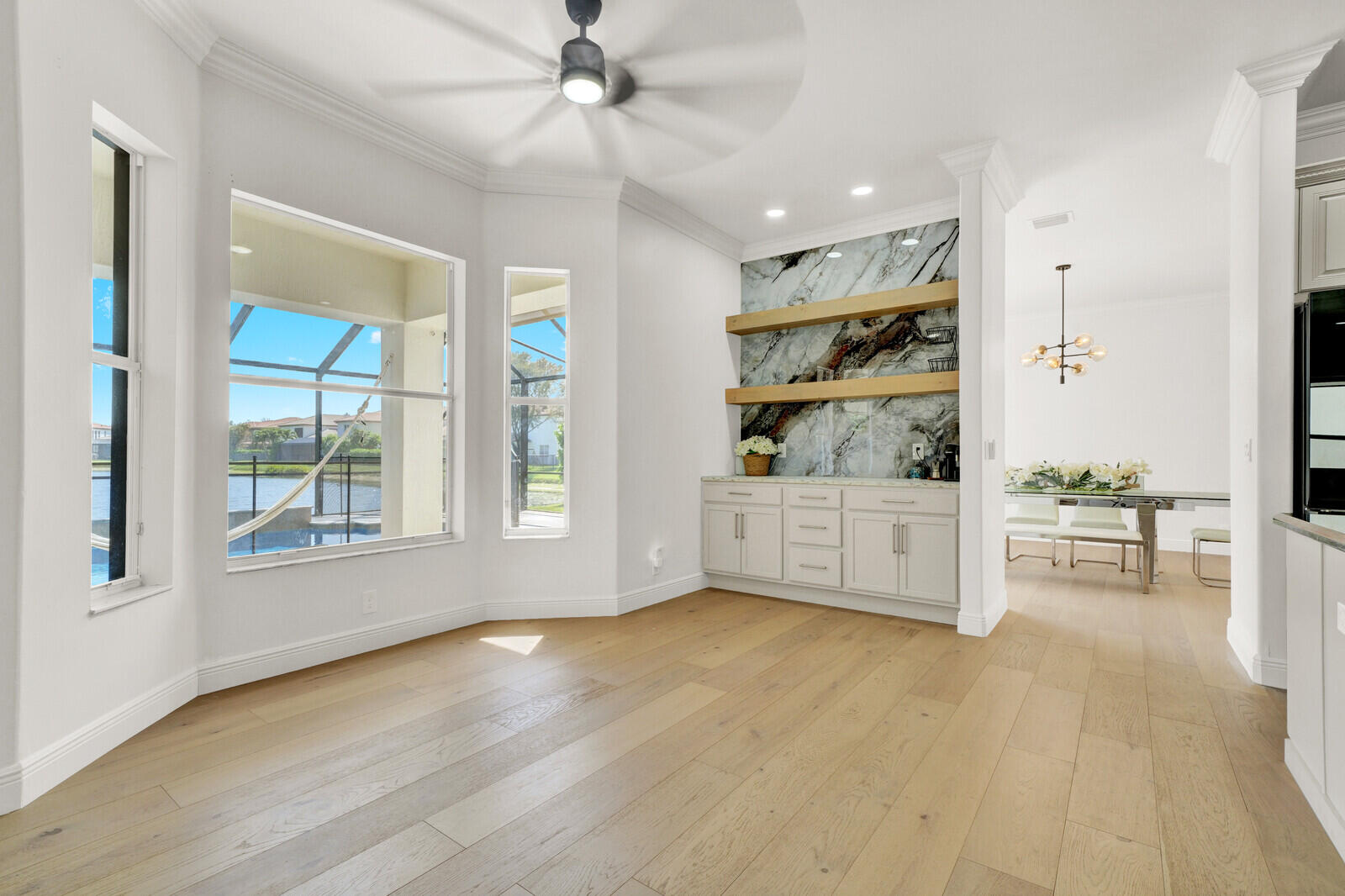 8685 Cobblestone Point Circle Boynton Beach, FL 33472 - Photo 16 of 70 a view of an empty room with a window and kitchen view