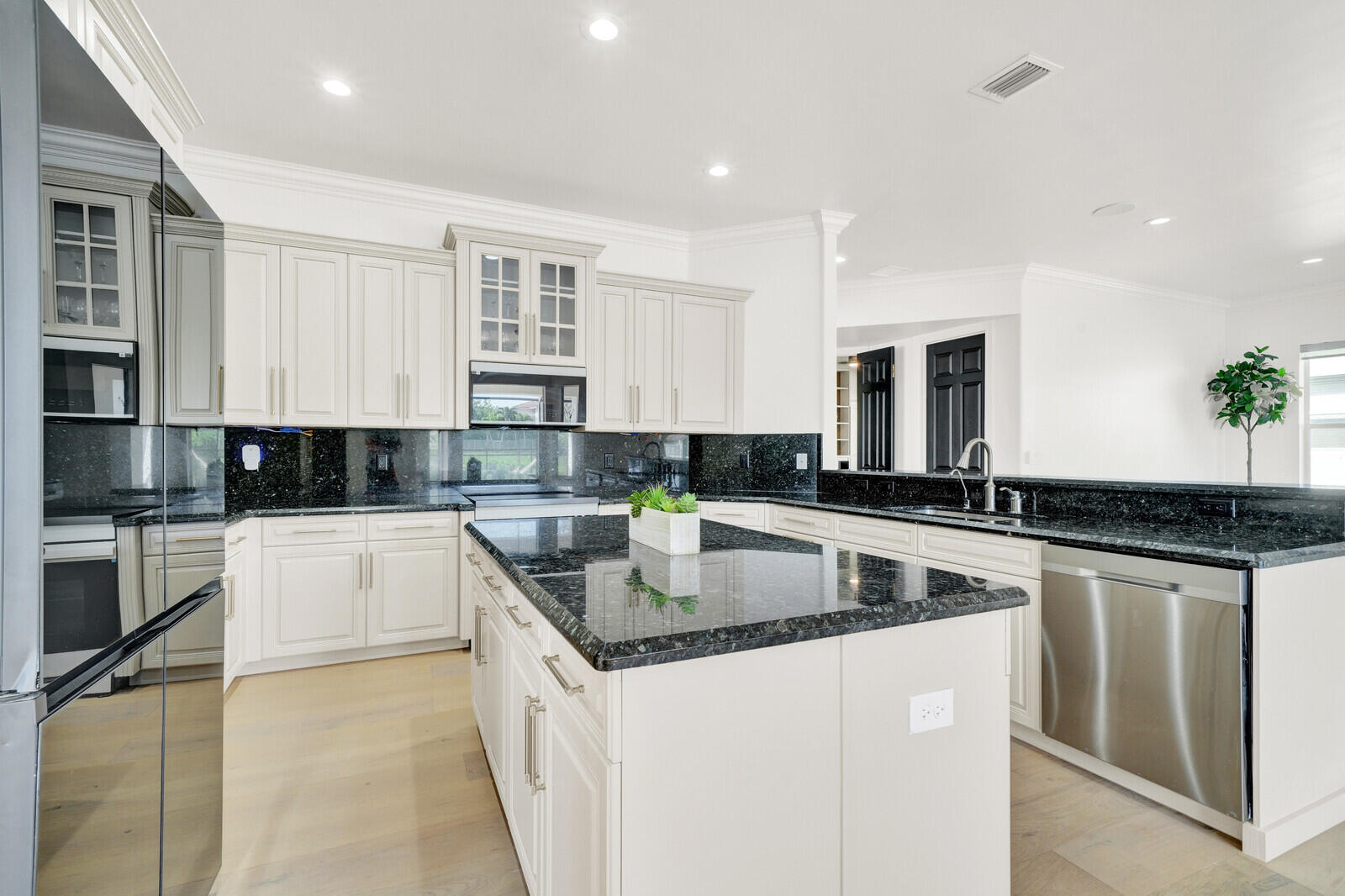 8685 Cobblestone Point Circle Boynton Beach, FL 33472 - Photo 20 of 70 a kitchen with stainless steel appliances granite countertop a stove top oven a sink a counter space and cabinets