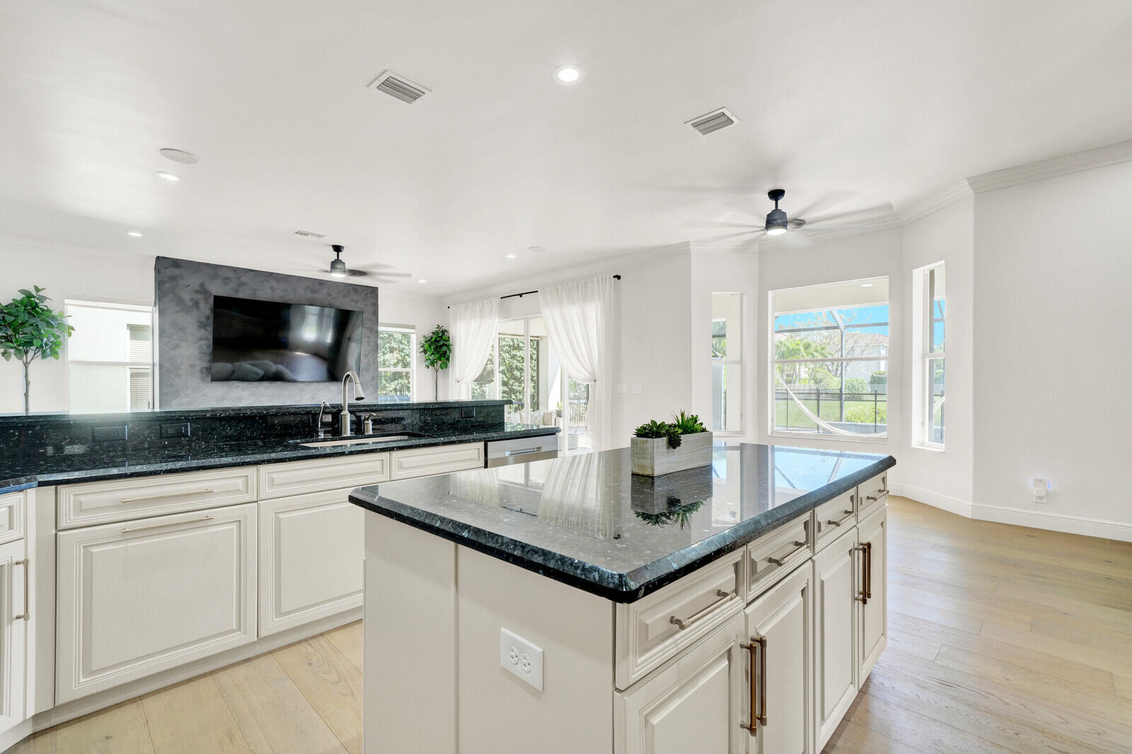 8685 Cobblestone Point Circle Boynton Beach, FL 33472 - Photo 21 of 70 a kitchen with granite countertop a sink and a white wooden cabinets