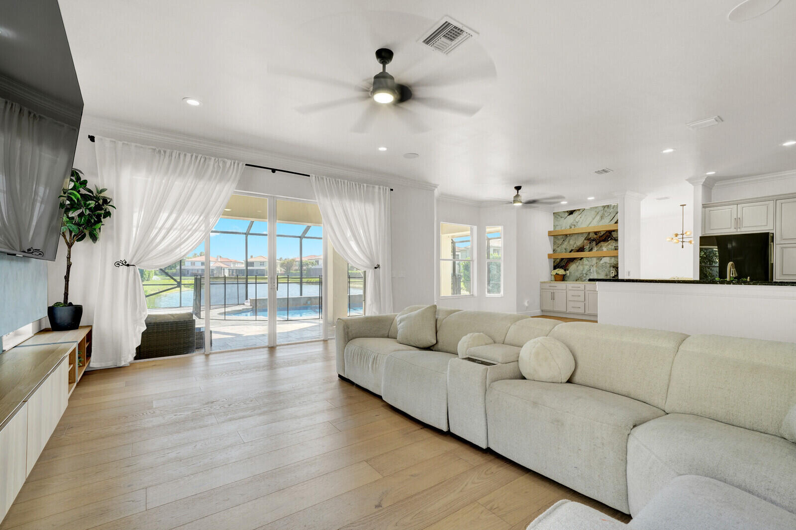 8685 Cobblestone Point Circle Boynton Beach, FL 33472 - Photo 24 of 70 a living room with furniture floor to ceiling window and a potted plant