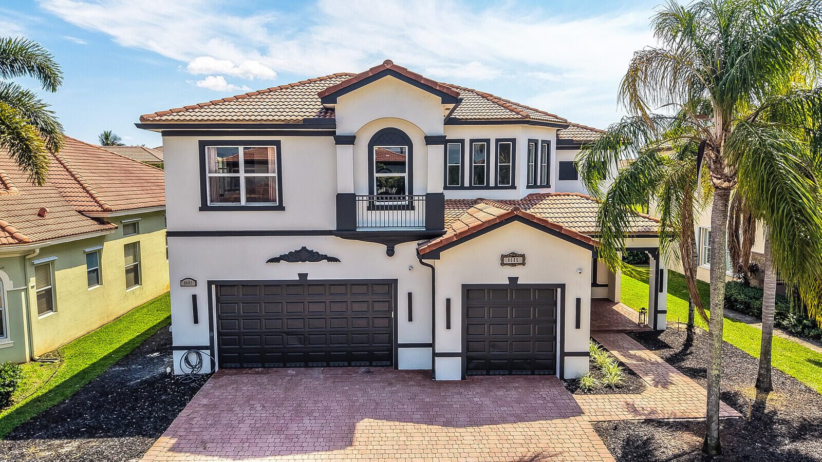 8685 Cobblestone Point Circle Boynton Beach, FL 33472 - Photo 56 of 70 a front view of a house with a garden