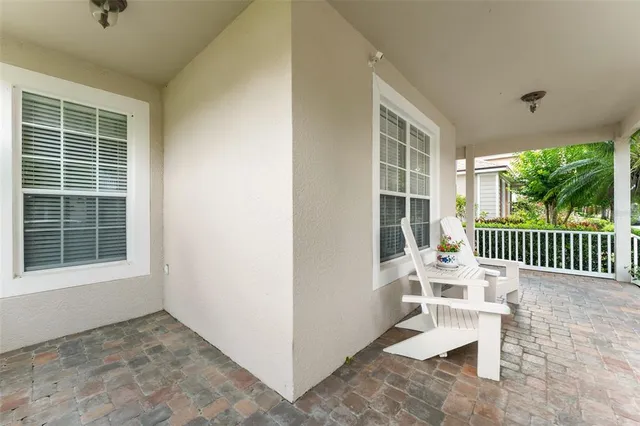 a view of a porch with a table and chairs