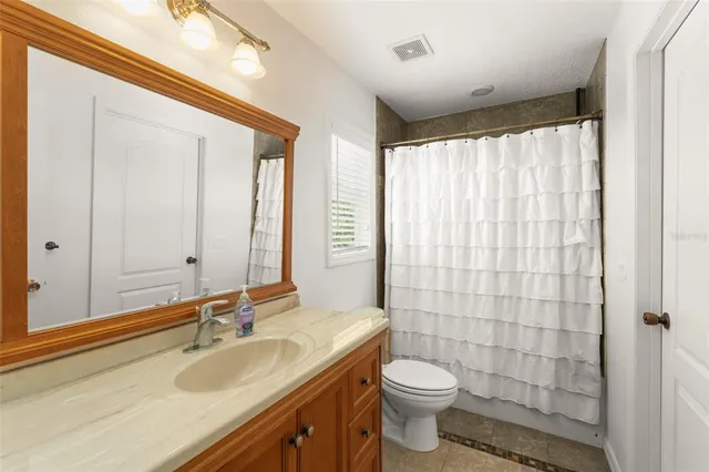 a bedroom with a bed closet and a window