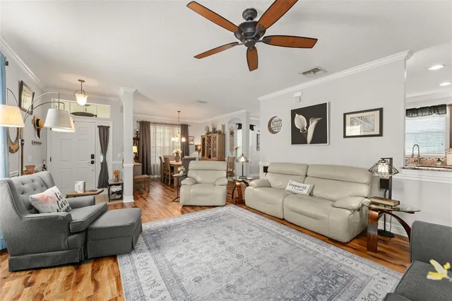 a living room with furniture and a view of kitchen
