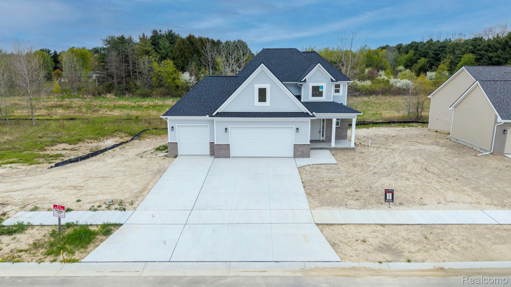 2361 Baltimore Davison, MI 48423 - Photo 2 of 31 Traditional home featuring covered porch, roof with shingles, driveway, and an attached garage