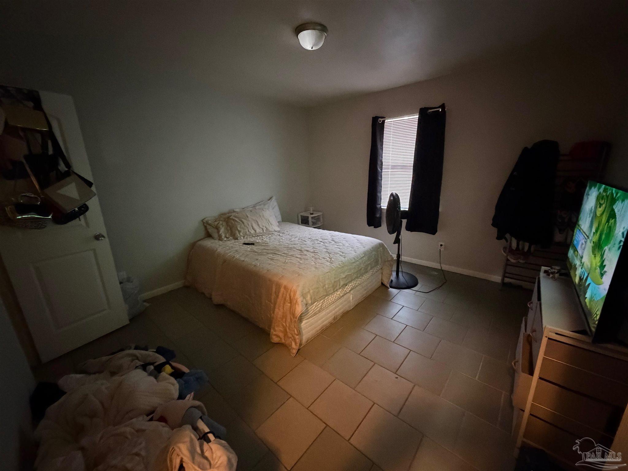 130 East 9 Mile Road Pensacola, FL 32534 - Photo 13 of 25 a bed sitting in a bedroom next to a window
