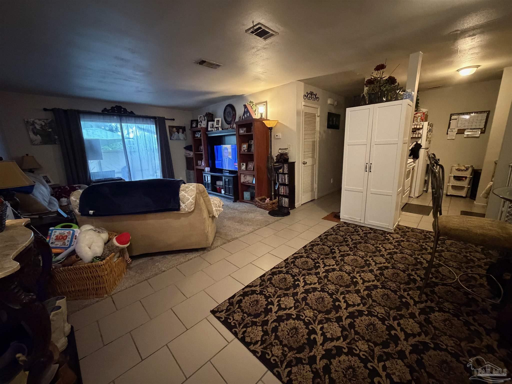 130 East 9 Mile Road Pensacola, FL 32534 - Photo 14 of 25 a living room with furniture and a flat screen tv
