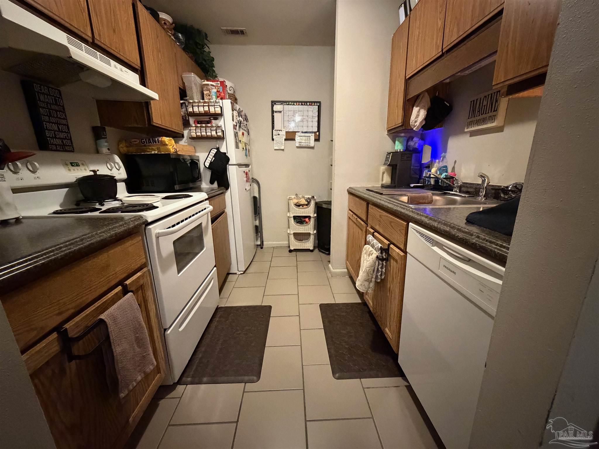 130 East 9 Mile Road Pensacola, FL 32534 - Photo 15 of 25 a kitchen with a stove top oven and cabinets
