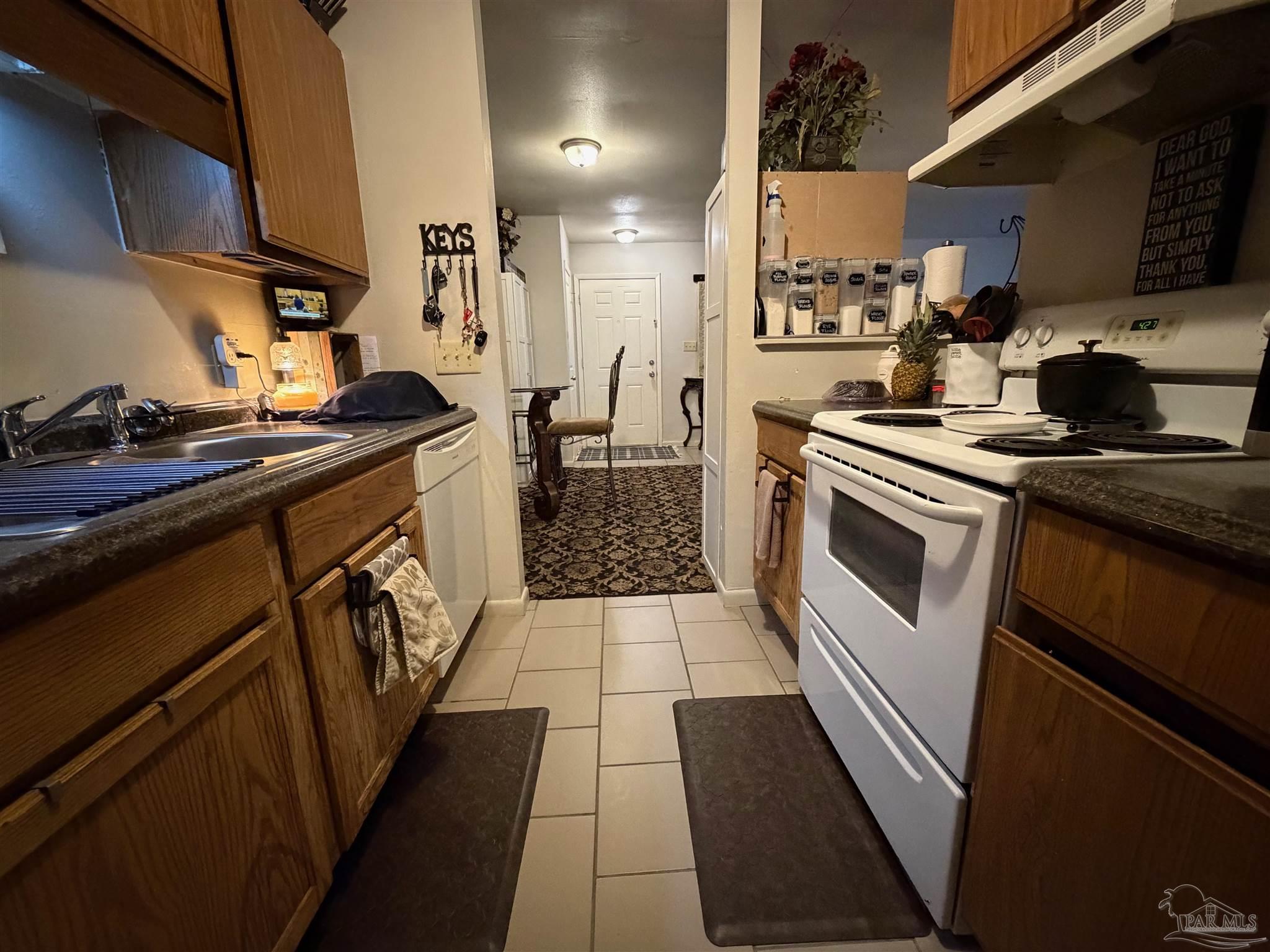 130 East 9 Mile Road Pensacola, FL 32534 - Photo 16 of 25 a kitchen with a sink a stove and cabinets