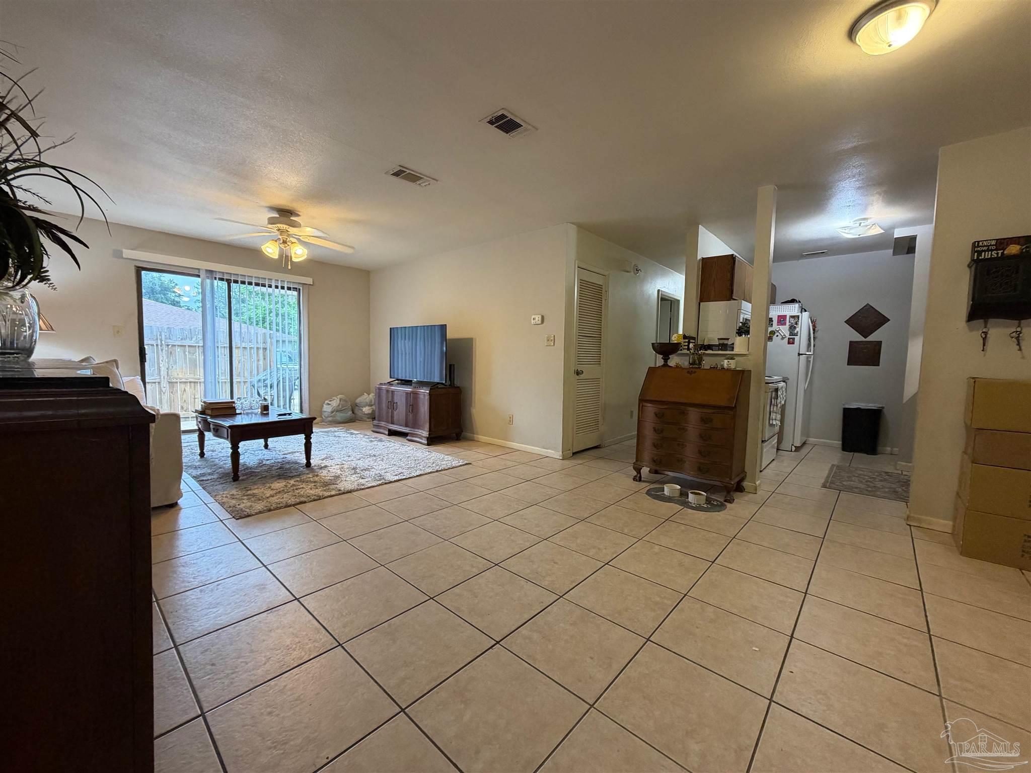 130 East 9 Mile Road Pensacola, FL 32534 - Photo 2 of 25 a view of a kitchen with furniture and a refrigerator