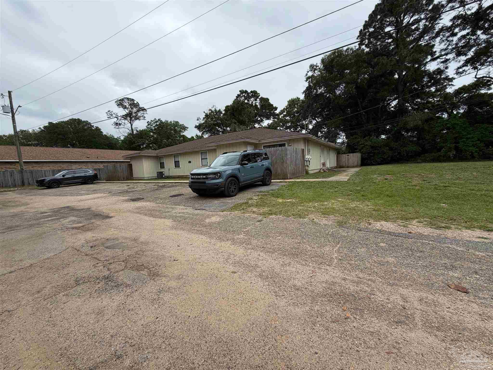 130 East 9 Mile Road Pensacola, FL 32534 - Photo 24 of 25 a view of backyard with barbeque grill and wooden fence