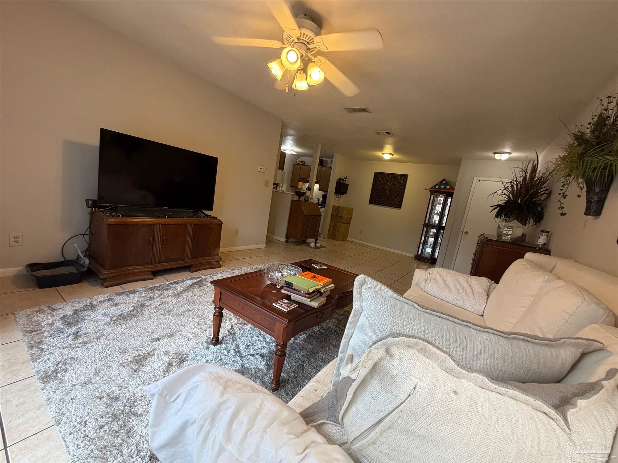 130 East 9 Mile Road Pensacola, FL 32534 - Photo 3 of 25 a living room with furniture and a flat screen tv