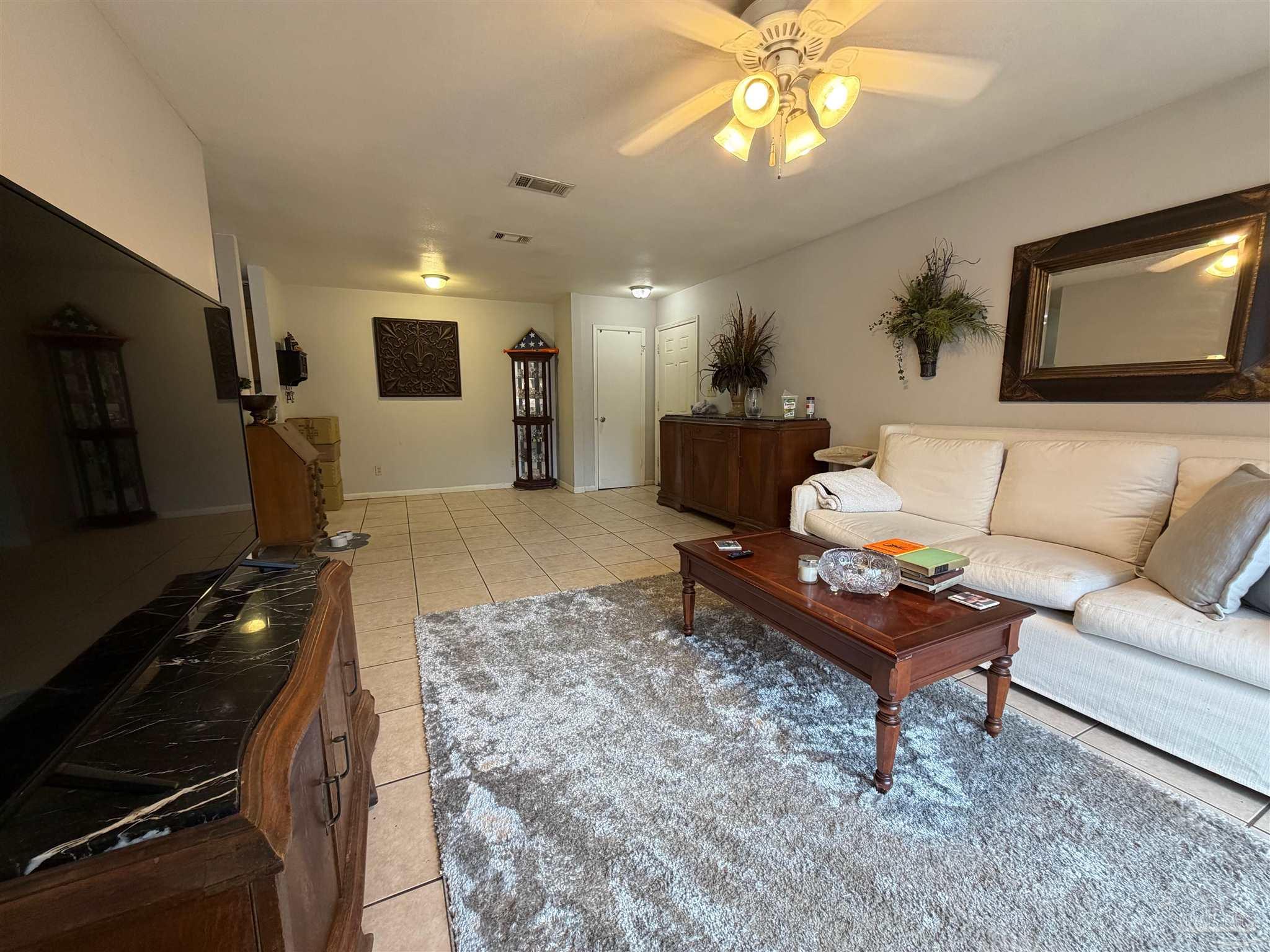 130 East 9 Mile Road Pensacola, FL 32534 - Photo 4 of 25 a living room with furniture and a flat screen tv