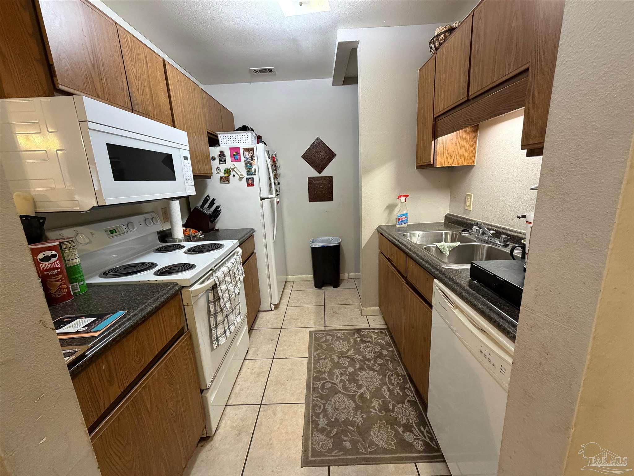 130 East 9 Mile Road Pensacola, FL 32534 - Photo 5 of 25 a kitchen with stainless steel appliances a stove a sink and a refrigerator