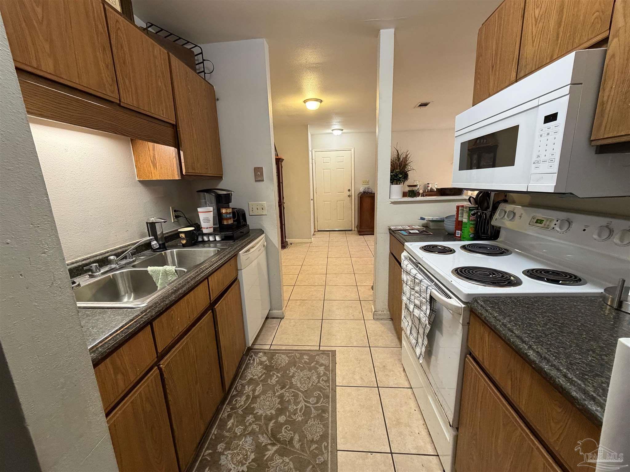 130 East 9 Mile Road Pensacola, FL 32534 - Photo 6 of 25 a kitchen with a sink a stove and cabinets