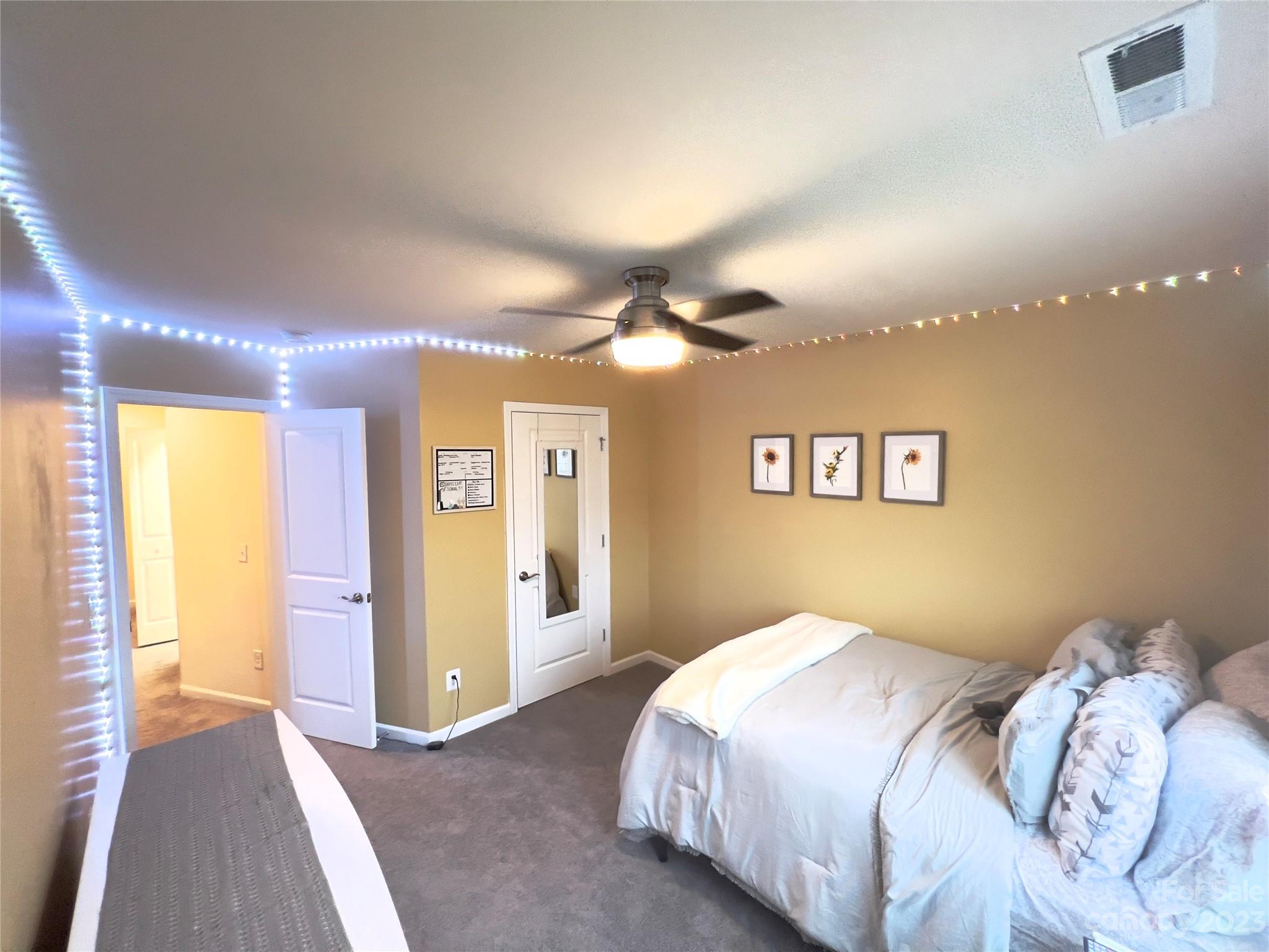 833 Canoe Song Road Fort Mill, SC 29708 - Photo 11 of 12 a bedroom with a bed and a chandelier