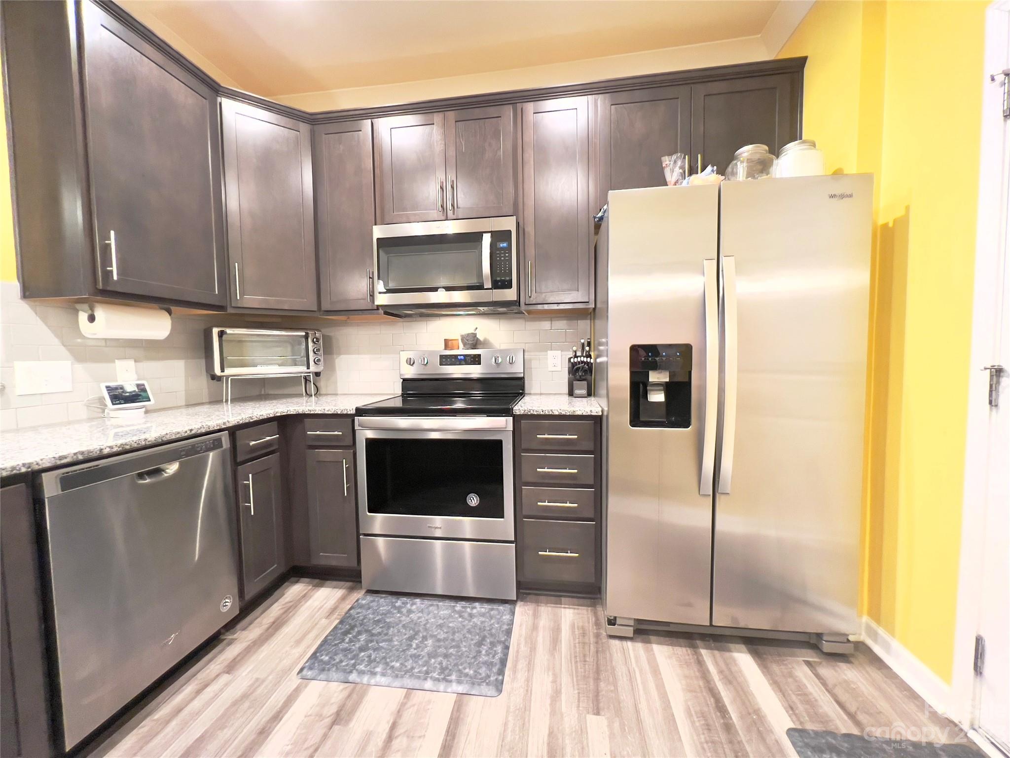 833 Canoe Song Road Fort Mill, SC 29708 - Photo 5 of 12 a kitchen with stainless steel appliances a refrigerator sink and microwave