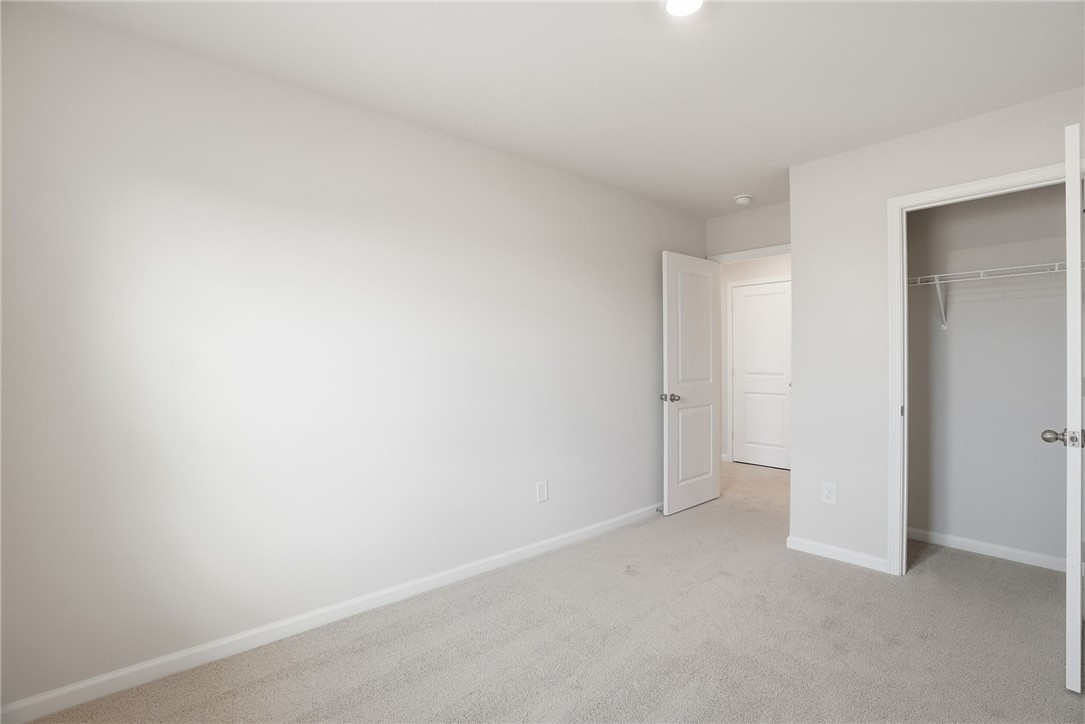 305 Lilac Loop Greenwood, SC 29646 - Photo 15 of 25 A spacious, naturally illuminated room featuring plush carpeting and a convenient walk-in closet.