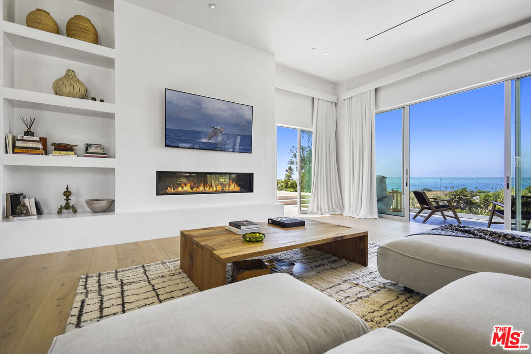 a living room with furniture rug and window