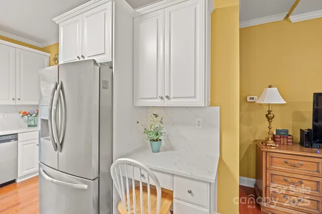 a kitchen with stainless steel appliances granite countertop a refrigerator and a sink