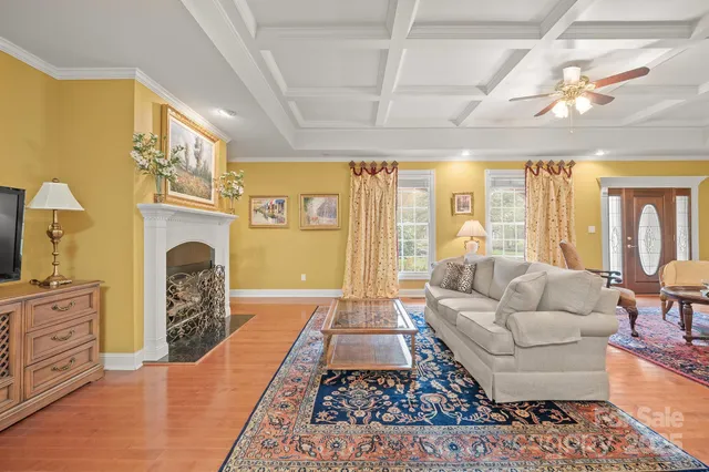 a living room with furniture fireplace and flat screen tv