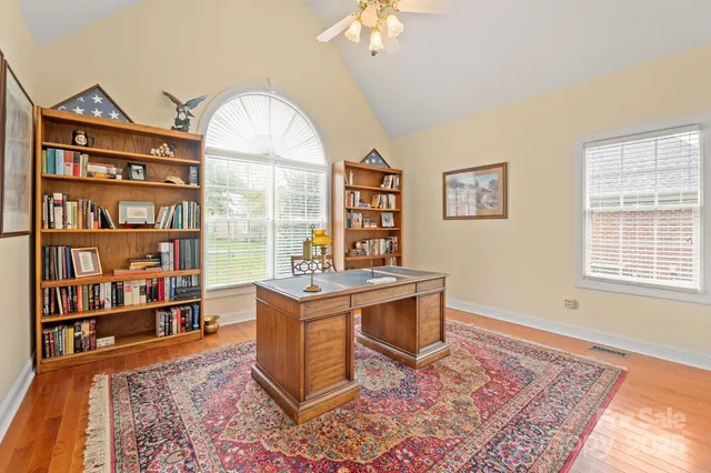 a view of a workspace with furniture and a bookshelf